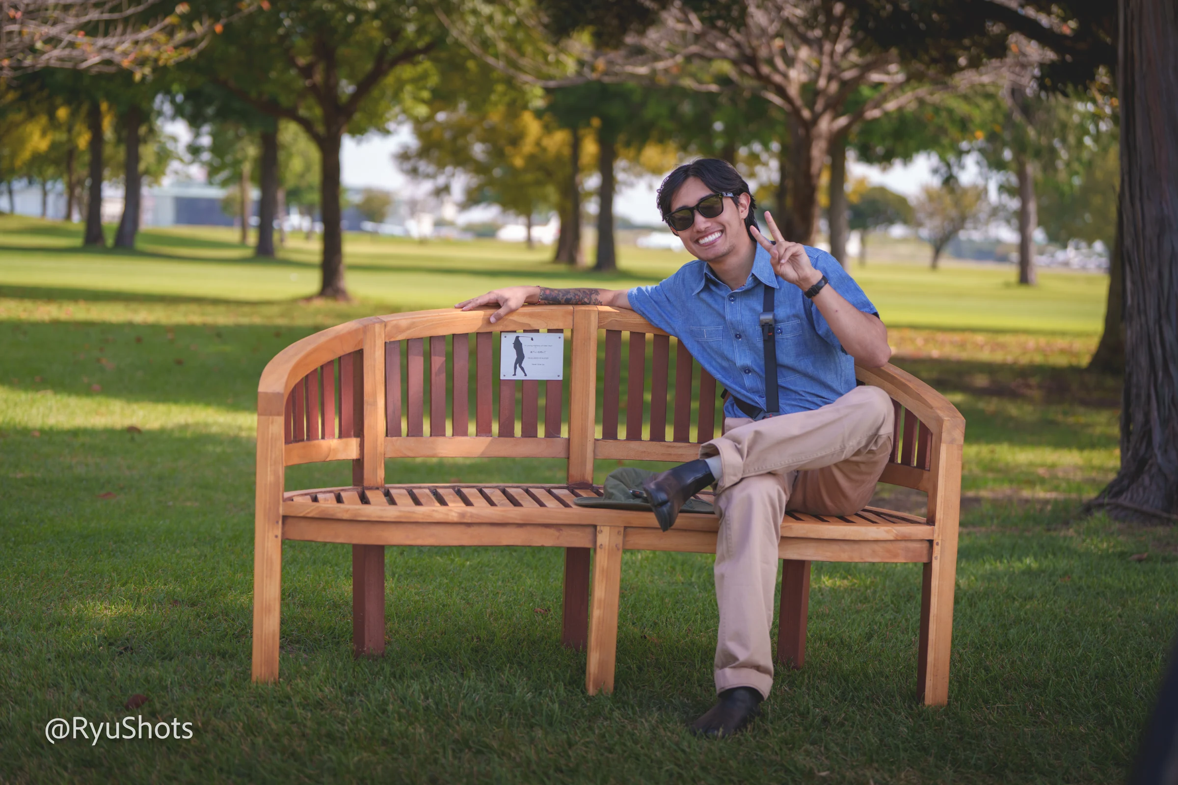 Erza seated on a wooden bench in a park